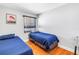 Comfortable bedroom with hardwood floors, two twin beds, and a window with blinds at 6515 Dimarco Rd, Tampa, FL 33634