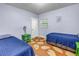 Twin bedroom with a unique floor, natural light, and calming blue color scheme at 6515 Dimarco Rd, Tampa, FL 33634