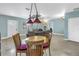 Cozy dining area featuring a round table, wood chairs, and a view of the living area at 6515 Dimarco Rd, Tampa, FL 33634