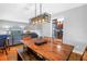 Open-concept dining area adjacent to the living room and kitchen, featuring hardwood floors at 6515 Dimarco Rd, Tampa, FL 33634
