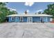 Blue multifamily house with seating area out front, ideal for a rental property at 6515 Dimarco Rd, Tampa, FL 33634
