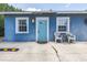 Back house with private entrance, small outdoor seating area and bright blue walls at 6515 Dimarco Rd, Tampa, FL 33634