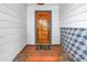 Inviting front entry with wooden door, patterned tile wall, and 