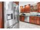 Modern kitchen with stainless steel appliances, wood cabinets, granite countertops, and tile backsplash at 6515 Dimarco Rd, Tampa, FL 33634