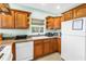 Kitchen features white appliances, granite counters, natural wood cabinets, and tile flooring at 6515 Dimarco Rd, Tampa, FL 33634