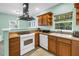 This eat-in kitchen features ample counter space, white appliances, and natural light at 6515 Dimarco Rd, Tampa, FL 33634