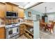 Updated kitchen featuring stainless steel appliances, granite countertops, and a dining area at 6515 Dimarco Rd, Tampa, FL 33634