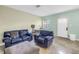 Comfortable living room featuring tile floors, natural lighting, and neutral paint at 6515 Dimarco Rd, Tampa, FL 33634