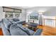 Cozy living room featuring a gray sofa, hardwood floors, and natural light from the window at 6515 Dimarco Rd, Tampa, FL 33634