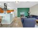 Cozy living room area with neutral walls and tile flooring and adjacent kitchen at 6515 Dimarco Rd, Tampa, FL 33634