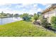 A serene water view complements the lush lawn of this gorgeous property at 6994 Country Lakes Cir, Sarasota, FL 34243