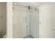 Modern bathroom with a frameless glass shower door, and a pebble floor accent at 6994 Country Lakes Cir, Sarasota, FL 34243