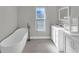 Bathroom featuring a freestanding tub, double vanity, and tile floor at 6994 Country Lakes Cir, Sarasota, FL 34243