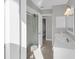 Well-lit bathroom featuring a glass-enclosed shower with stone flooring and a modern vanity at 6994 Country Lakes Cir, Sarasota, FL 34243