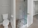 Clean bathroom featuring a glass shower with pebble floor and white fixtures at 6994 Country Lakes Cir, Sarasota, FL 34243