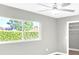 Bedroom with neutral paint, tile floors, natural light, and closet at 6994 Country Lakes Cir, Sarasota, FL 34243