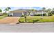 Charming one-story home featuring a tile roof, manicured lawn, and a two-car garage at 6994 Country Lakes Cir, Sarasota, FL 34243