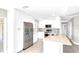 This is a kitchen with stainless steel appliances, white cabinets, and a breakfast bar area at 6994 Country Lakes Cir, Sarasota, FL 34243