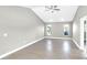 Spacious living room with neutral paint, tile floors, vaulted ceiling, and natural light at 6994 Country Lakes Cir, Sarasota, FL 34243