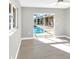 Bright living room with sliding glass doors offering a seamless transition to the outdoor pool area at 6994 Country Lakes Cir, Sarasota, FL 34243