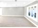 Bright living room boasting contemporary wood flooring and large windows for plenty of light at 6994 Country Lakes Cir, Sarasota, FL 34243