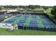 Aerial view of numerous pickleball courts at Palm Aire Country Club at 6994 Country Lakes Cir, Sarasota, FL 34243