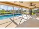 Inviting screened-in pool area offering serene water views and ample space for relaxation and recreation at 6994 Country Lakes Cir, Sarasota, FL 34243