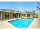 A relaxing pool area with a screened in enclosure and bright blue water at 6994 Country Lakes Cir, Sarasota, FL 34243