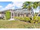 Large screened-in lanai, great for outdoor entertaining, with lush landscape views at 6994 Country Lakes Cir, Sarasota, FL 34243