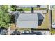 Aerial shot directly above the house showing the roof, yard, and adjacent street with a car parked in the driveway at 7508 S Mascotte St, Tampa, FL 33616