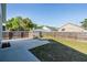 Fully fenced backyard with a shed, grass, and a concrete patio at 7508 S Mascotte St, Tampa, FL 33616