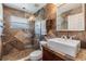 Modern bathroom featuring travertine tile, glass enclosed shower, and a vessel sink at 7508 S Mascotte St, Tampa, FL 33616