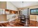 Dining area with hardwood floors and modern lighting fixtures, adjacent to the kitchen at 7508 S Mascotte St, Tampa, FL 33616