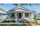 Inviting front exterior with a classic porch, showcasing fresh landscaping and a bright red front door at 7508 S Mascotte St, Tampa, FL 33616