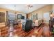 Living room area with hardwood floors, a ceiling fan, and a view of the dining area at 7508 S Mascotte St, Tampa, FL 33616
