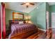Spacious primary bedroom featuring hardwood flooring, green walls, and a ceiling fan at 7508 S Mascotte St, Tampa, FL 33616