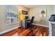 Home office with wood floors, desk, chair, and window at 7508 S Mascotte St, Tampa, FL 33616