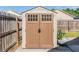 Exterior shot of a backyard shed, featuring double doors and a side planter at 7508 S Mascotte St, Tampa, FL 33616