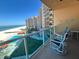 Spacious balcony with a stunning view of pool, and beach at 880 Mandalay Ave # S511, Clearwater Beach, FL 33767