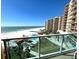 Balcony view of ocean, beach, pool and tropical grounds of building from elevated vantage point at 880 Mandalay Ave # S511, Clearwater Beach, FL 33767