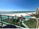 Balcony view of ocean, beach, pool and tropical grounds of building from elevated vantage point at 880 Mandalay Ave # S511, Clearwater Beach, FL 33767