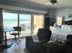 Bright main bedroom with king bed, ceiling fan, and sliding glass doors leading to ocean view balcony at 880 Mandalay Ave # S511, Clearwater Beach, FL 33767