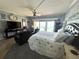 Bright main bedroom with king bed, ceiling fan, and sliding glass doors leading to ocean view balcony at 880 Mandalay Ave # S511, Clearwater Beach, FL 33767