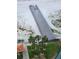 Aerial view of a wooden pier that leads to a sandy beach with palm trees and a grassy area at 880 Mandalay Ave # S511, Clearwater Beach, FL 33767
