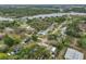 A picturesque aerial view captures the tranquil neighborhood surrounded by lush greenery and sparkling waters at 8805 Van Fleet Rd, Riverview, FL 33578