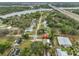 An aerial view highlights a charming neighborhood, showcasing the homes' proximity to waterways and a bridge at 8805 Van Fleet Rd, Riverview, FL 33578