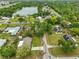 A beautiful aerial view showcases homes with well-maintained lawns nestled amongst trees and tranquil water features at 8805 Van Fleet Rd, Riverview, FL 33578