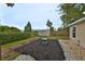 Landscaped backyard with a shed, mulch, and stone ground cover at 8805 Van Fleet Rd, Riverview, FL 33578