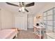 This carpeted bedroom features a closet, a white desk, and a wall calendar at 8805 Van Fleet Rd, Riverview, FL 33578
