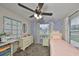 Bright bedroom featuring a ceiling fan, a large calendar, and a desk at 8805 Van Fleet Rd, Riverview, FL 33578